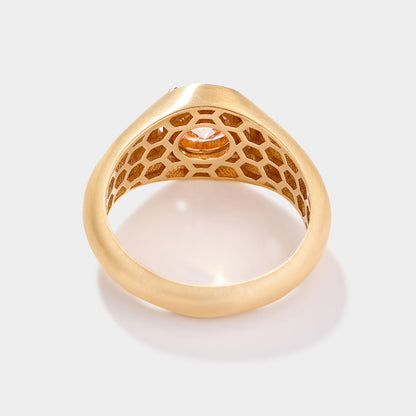 Gold ring with honeycomb design and central gemstone on a white background