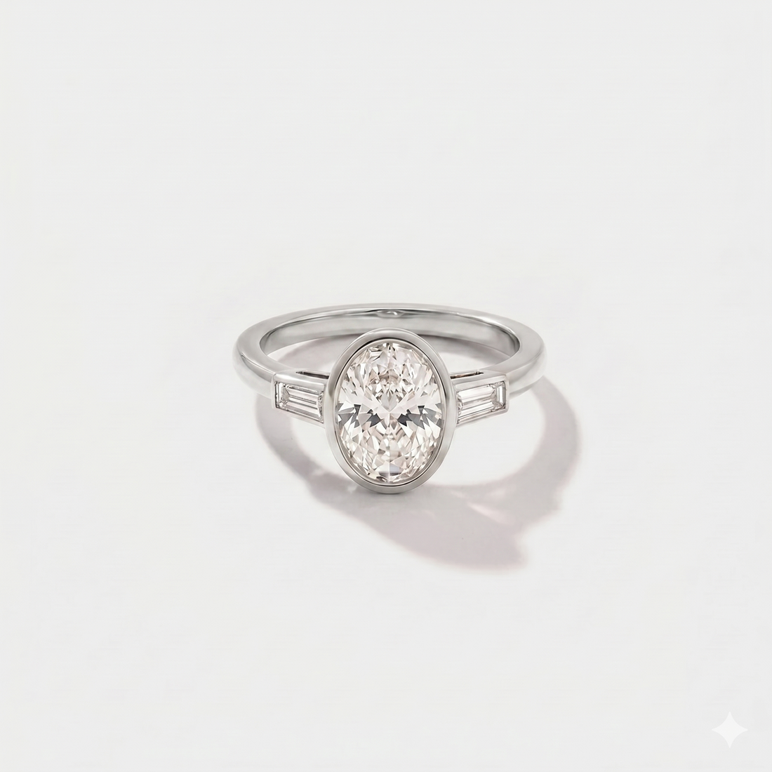 Oval bezel baguette solitaire lab-grown diamond engagement ring in 14K white gold by Cove Fine Jewelry