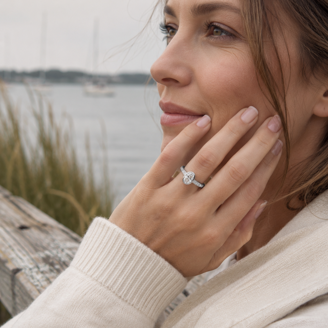 Close-up of oval bezel channel set solitaire engagement ring handcrafted by Cove Fine Jewelry