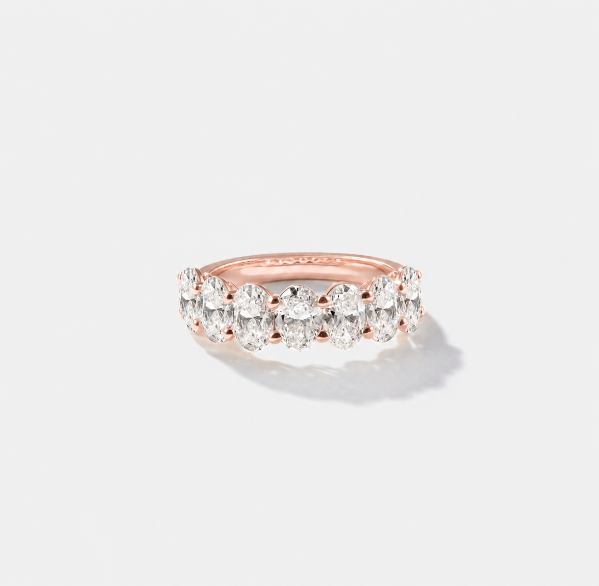 Oval-cut lab-grown diamond eternity band with shared prongs in polished rose gold