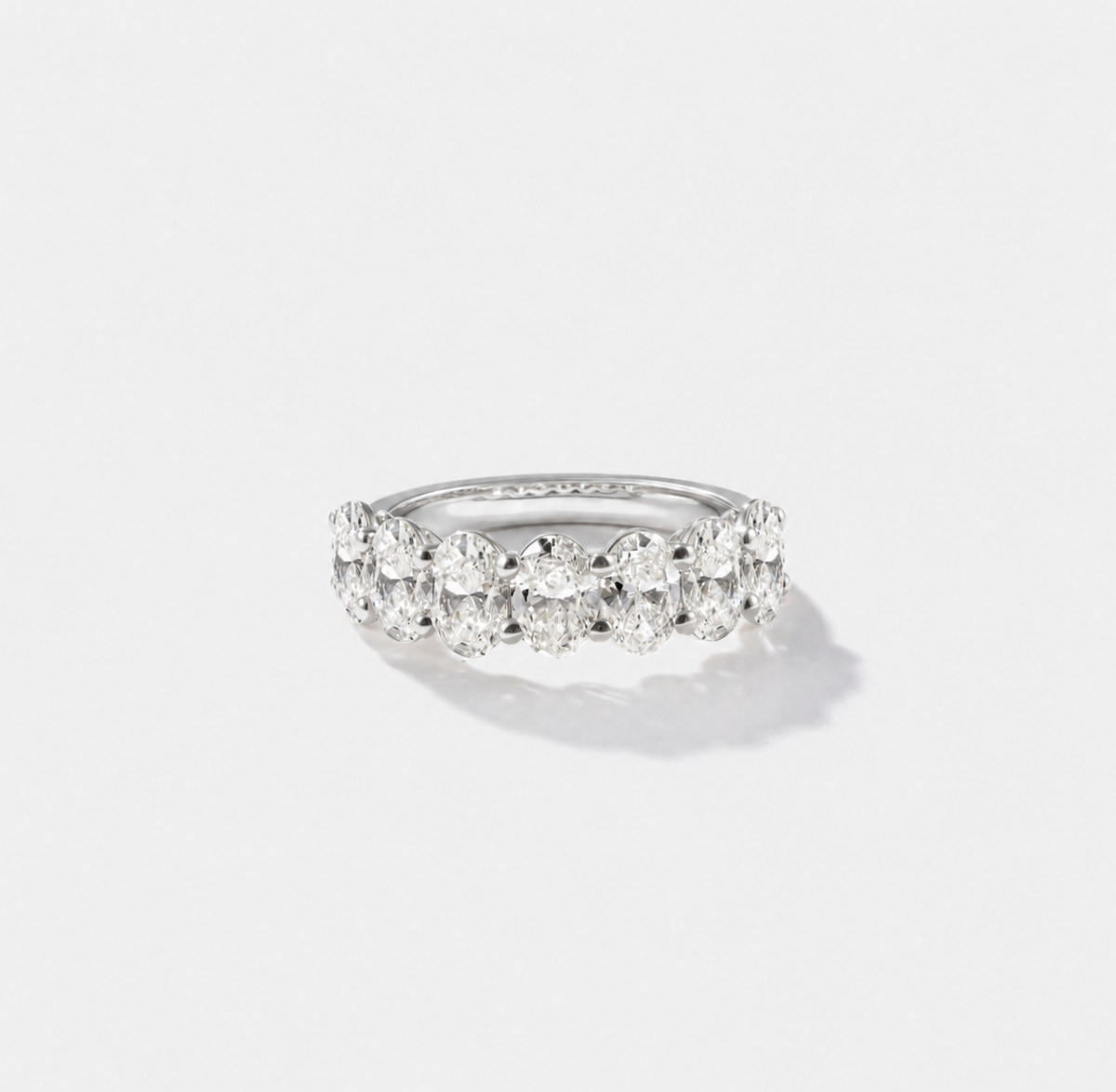 Oval-cut lab-grown diamond eternity band with shared prongs in polished white gold.