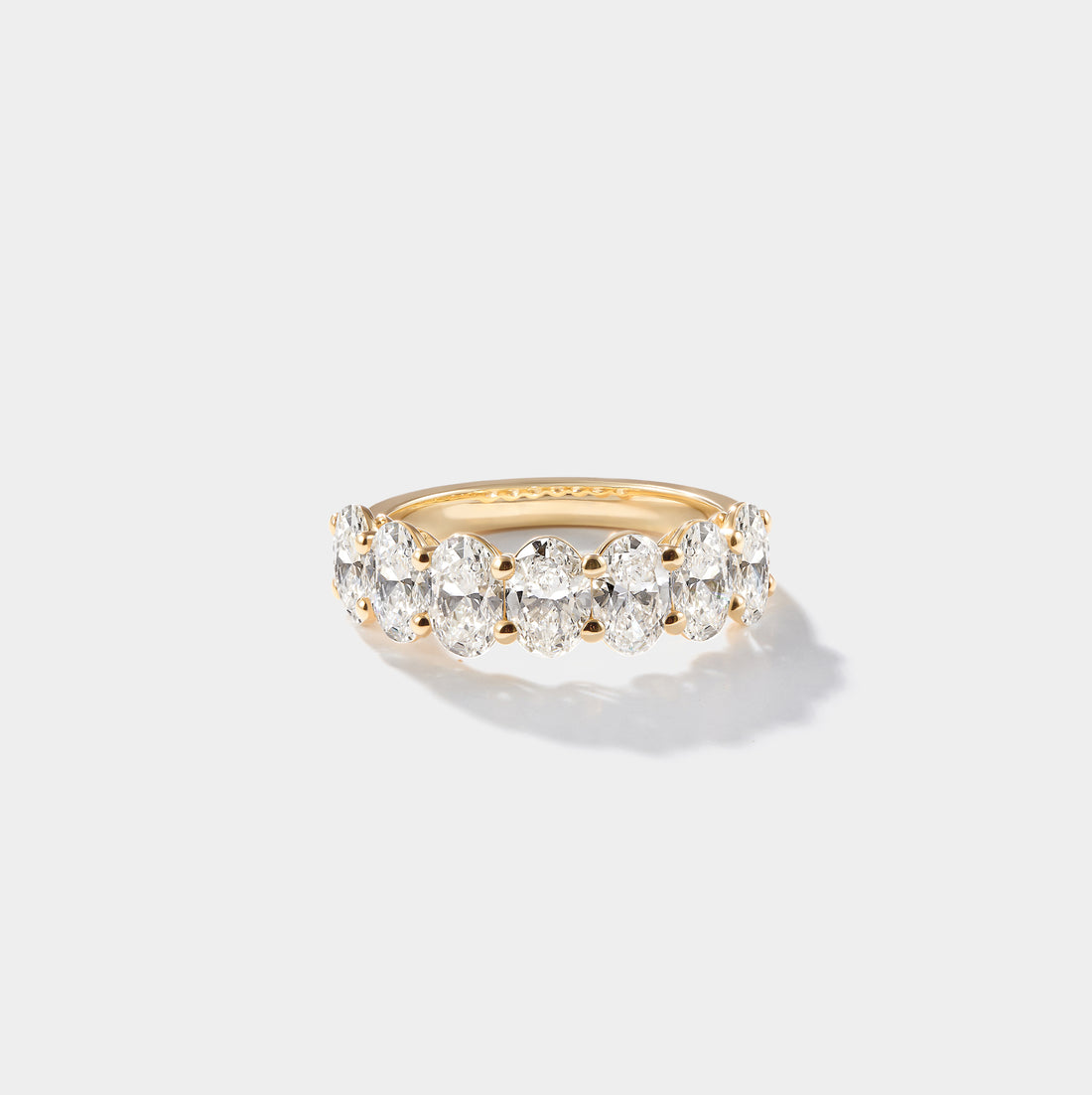 Oval-cut lab-grown diamond eternity band with a shared-prong setting in 14K yellow gold.