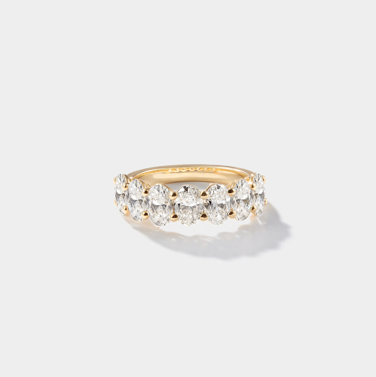 Oval-cut lab-grown diamond eternity band with a shared-prong setting in 14K yellow gold.