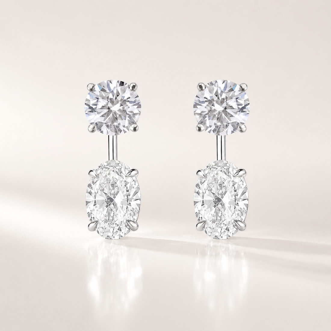 Ebb &amp; Flow lab-grown diamond earring jacket with a round diamond stud and oval diamond dangle in white gold.
