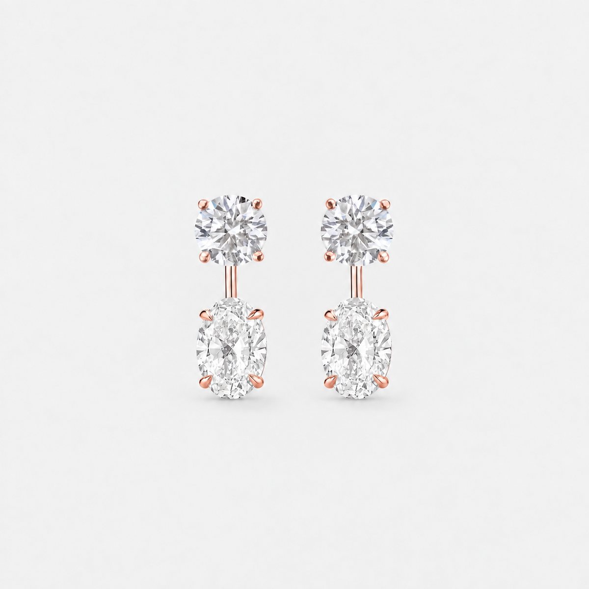 Round lab-grown diamond studs with oval lab-grown diamond earring jackets in polished rose gold.