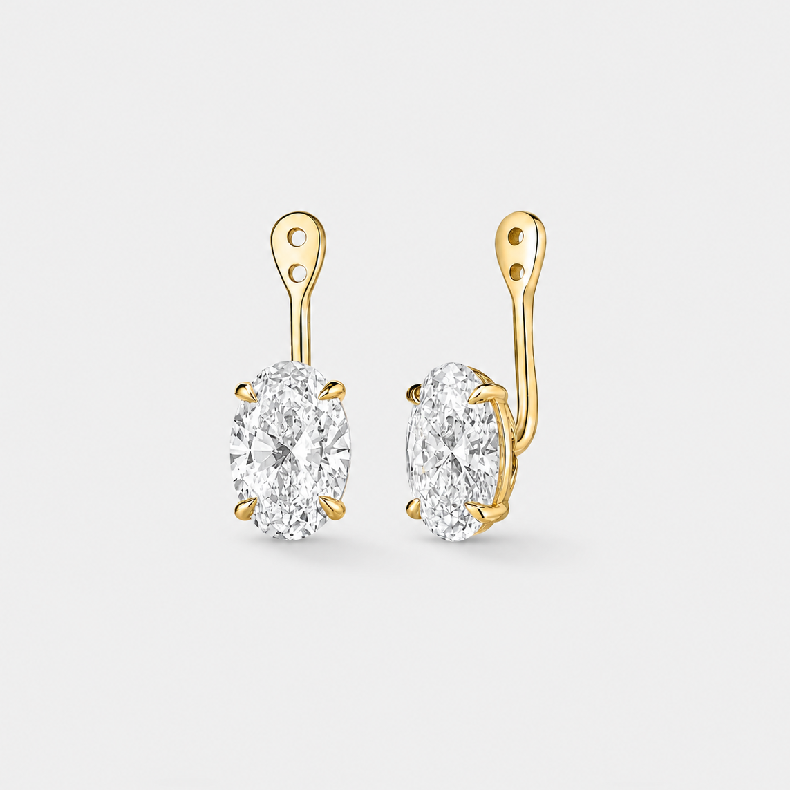 Front and angled views of 4 carat oval lab-grown diamond earring jackets in 14k yellow gold.