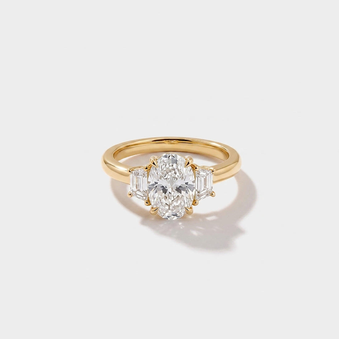 Oval three stone lab-grown diamond engagement ring in 14K yellow gold by Cove Fine Jewelry