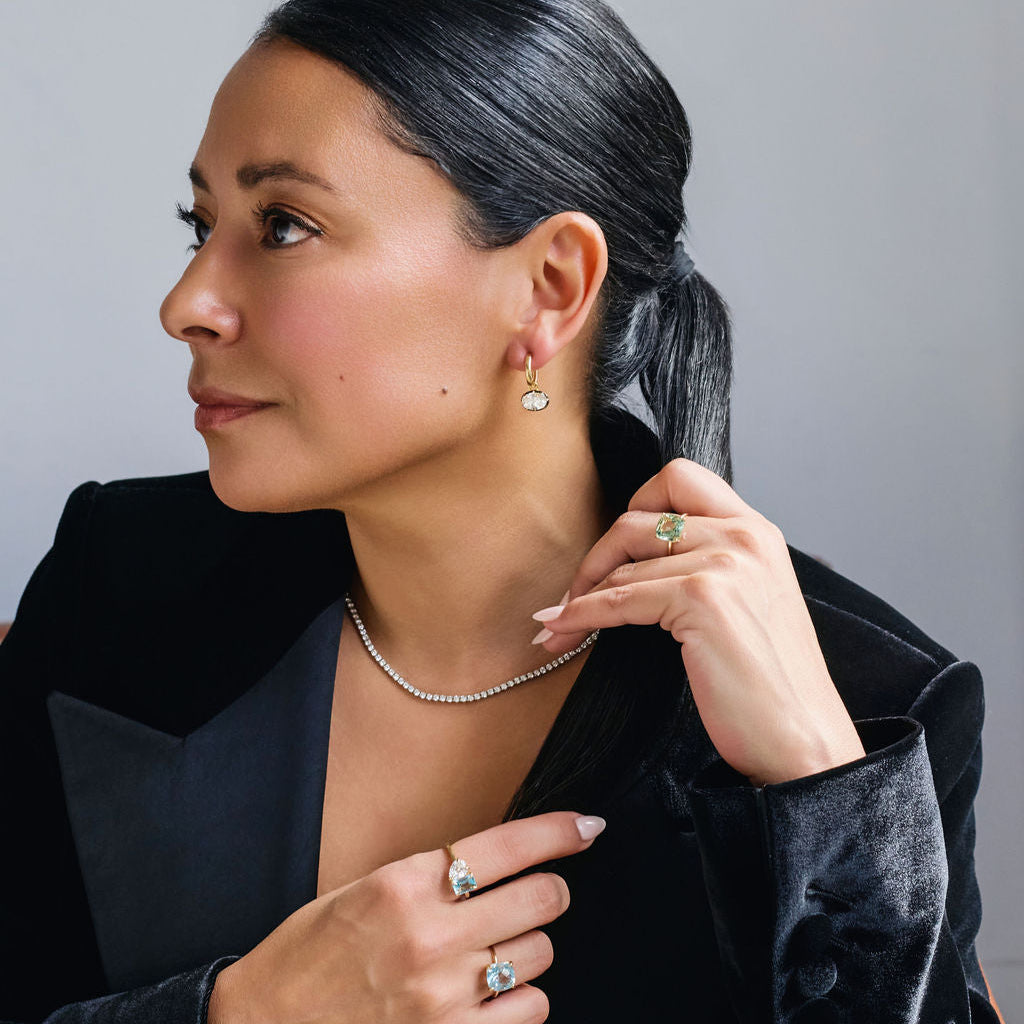 Model wearing green amethyst parasolite ring in solid 14k gold featuring a large cushion cut mint green gemstone