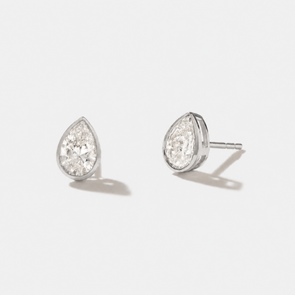 Pear-cut diamond stud earrings in polished white gold bezel settings