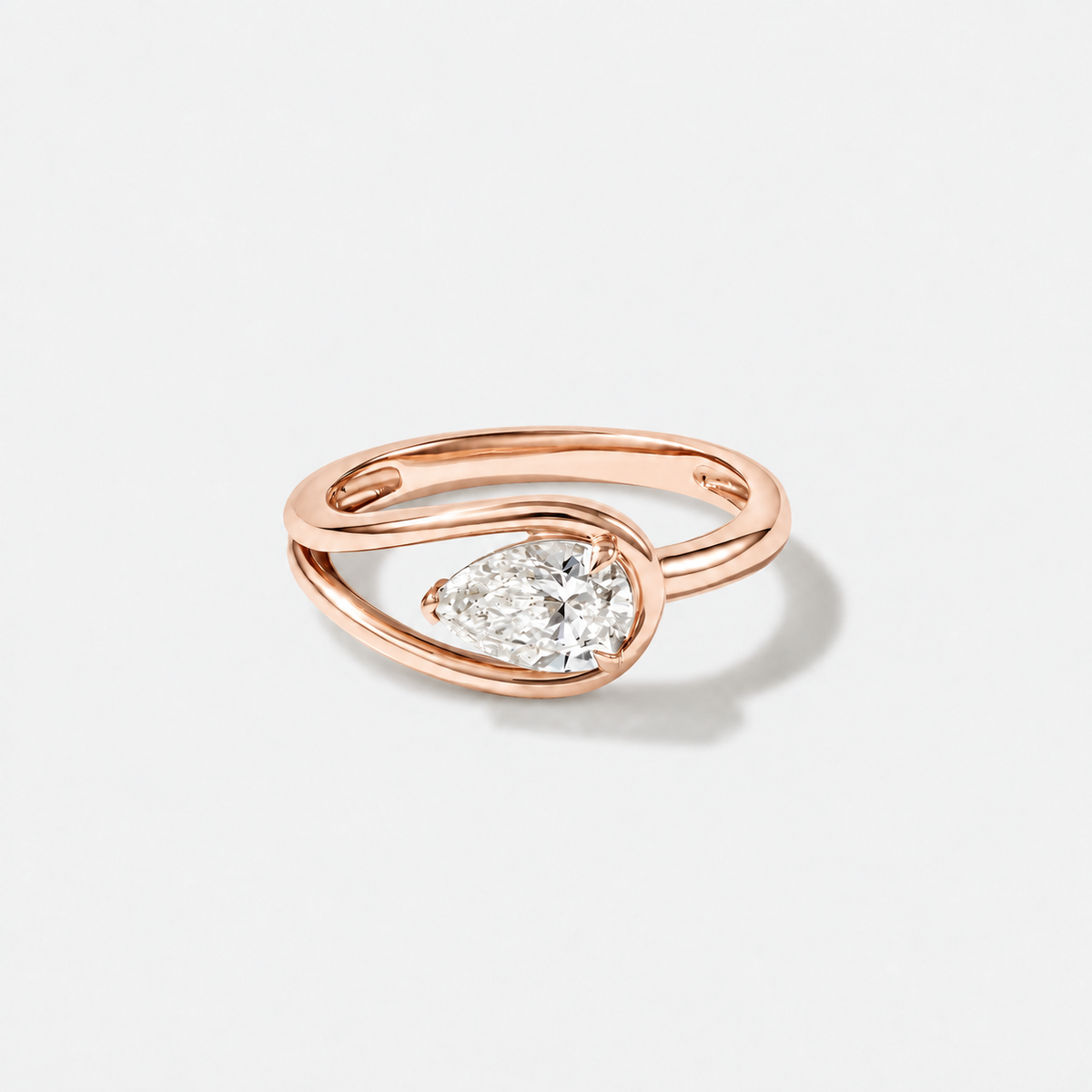 pear-shaped lab-grown diamond ring in 14K rose gold with a modern wrap setting.