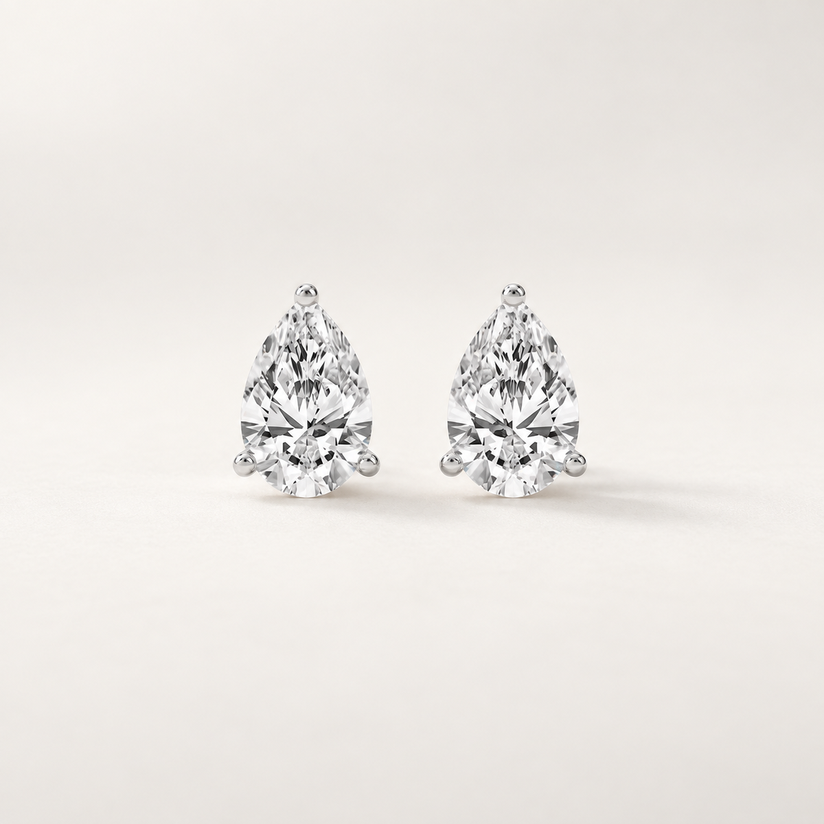 Pear-shaped lab-grown diamond stud earrings in polished white gold three-prong settings
