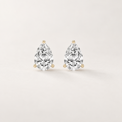 Front and side views of pear-shaped lab-grown diamond stud earrings in yellow gold