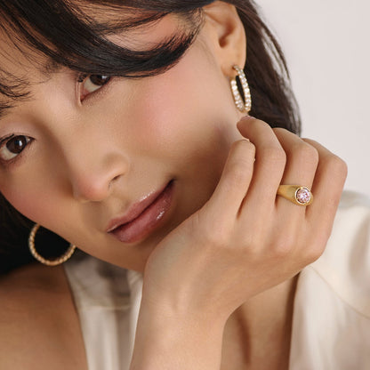 Editorial hand shot featuring matte gold pink diamond ring with soft feminie