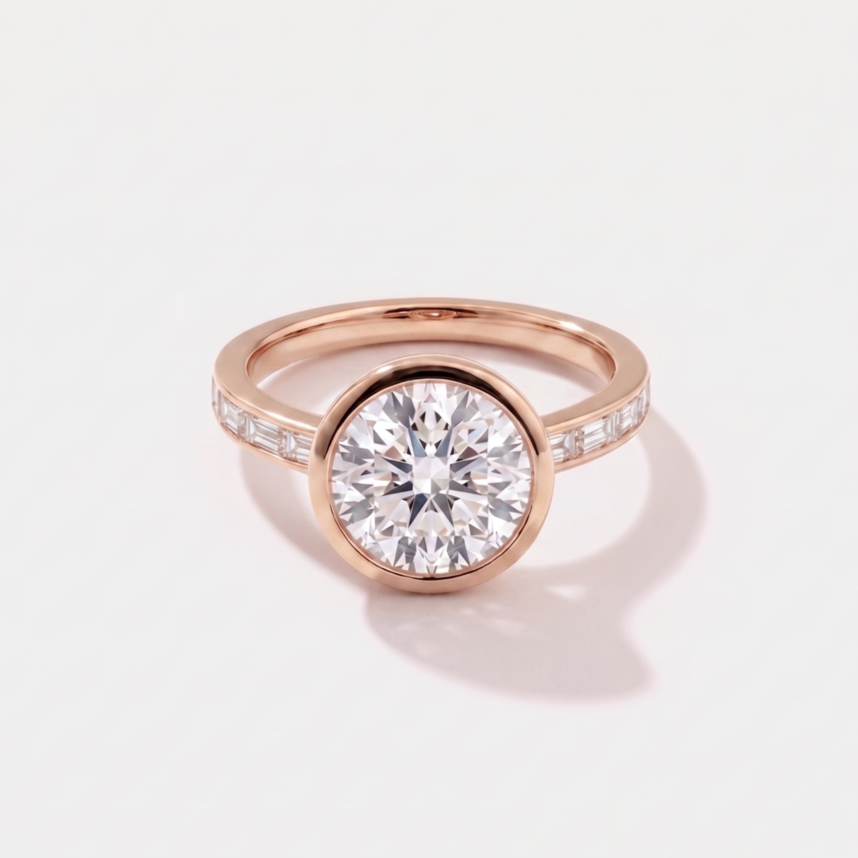 Round channel set solitaire lab-grown diamond engagement ring in 14K rose gold by Cove Fine Jewelry