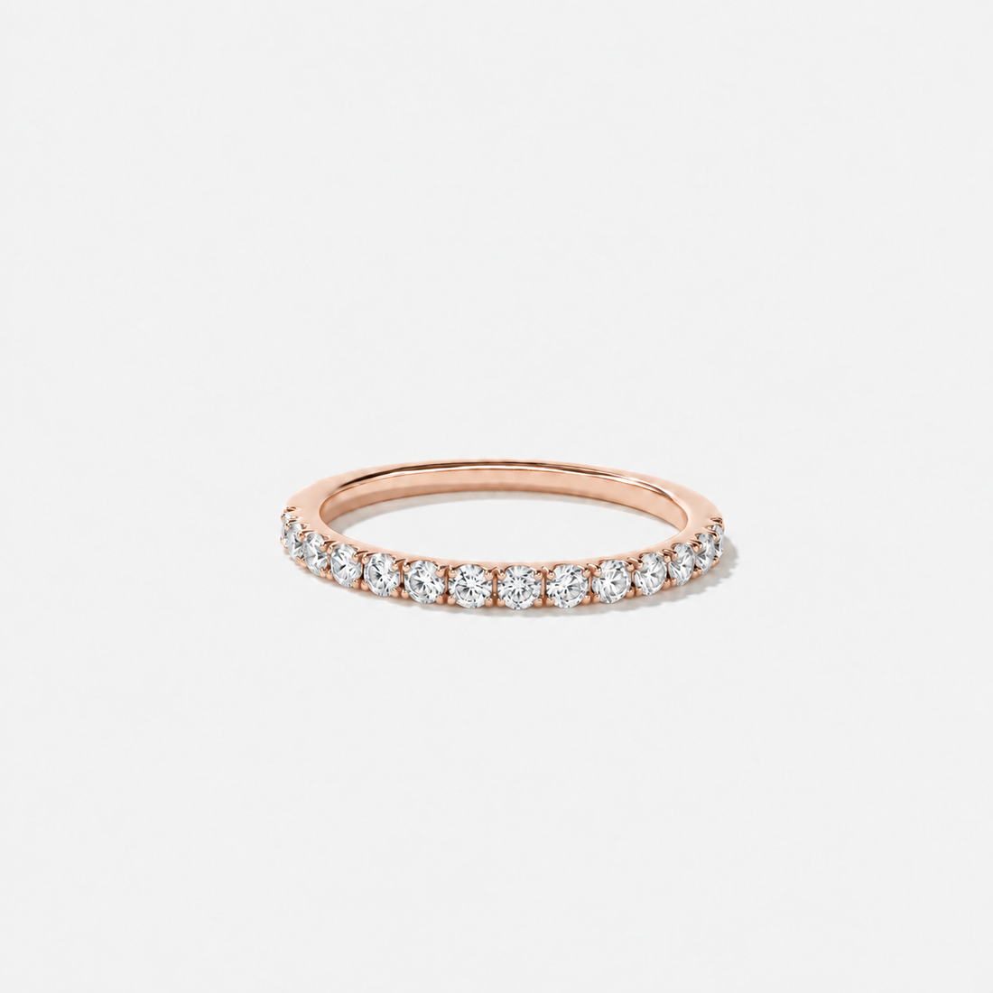 Round lab-grown diamond wedding band featuring a petite shared-prong setting in polished rose gold