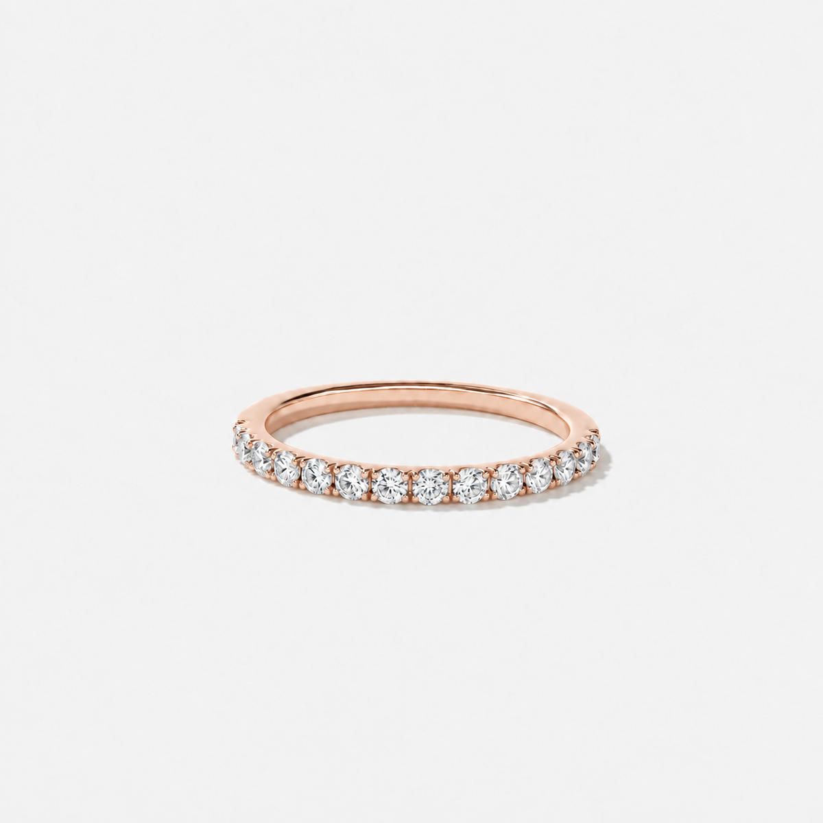 Round lab-grown diamond wedding band featuring a petite shared-prong setting in polished rose gold