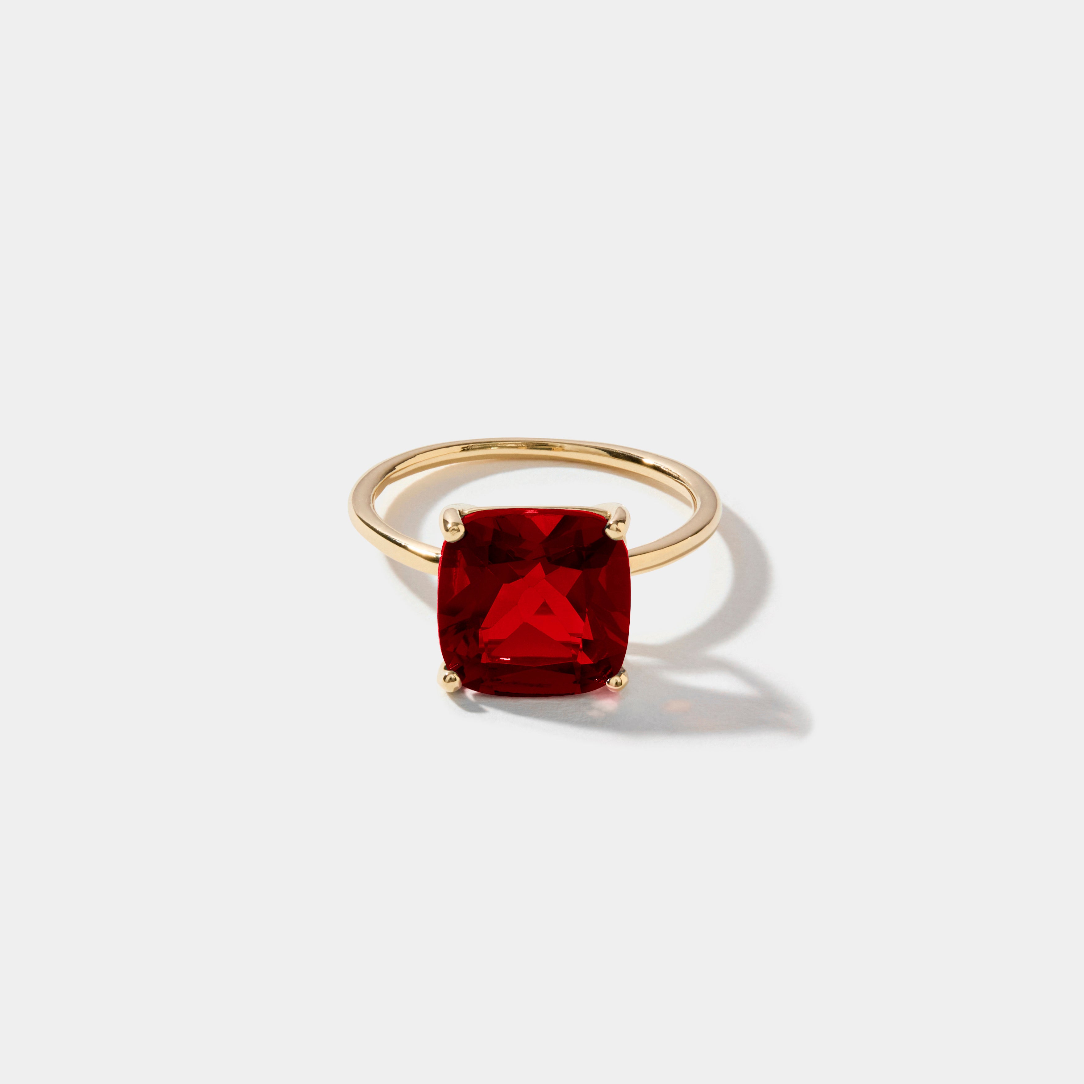 Cushion cut ruby statement ring with 10 mm lab grown ruby gemstone set in polished 14k gold.