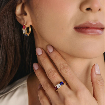 Close-up of cushion-cut lab-grown diamond ring with ruby and sapphire side stones in three-stone setting