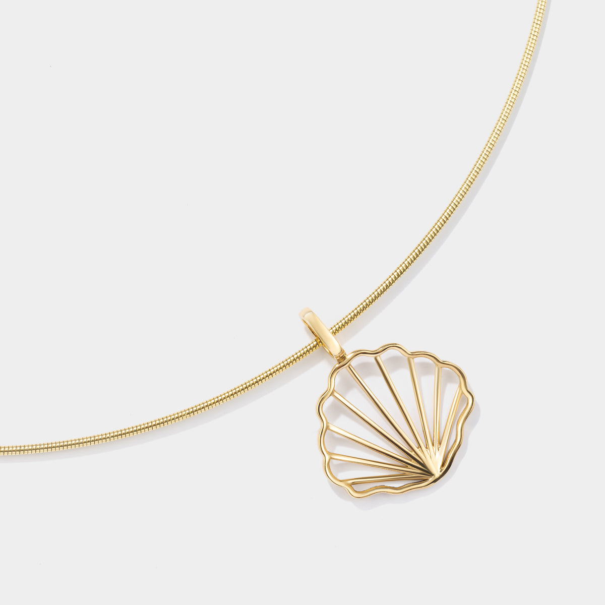 14K solid gold scallop shell pendant inspired by Cape Cod coastal jewelry traditions.