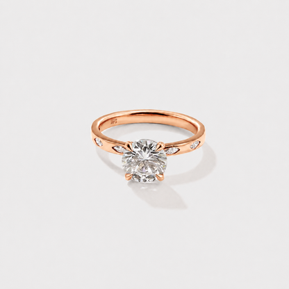 Classic round solitaire diamond ring with delicate marquise diamond side accents.