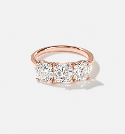 Three-stone cushion-cut lab-grown diamond ring in 14k rose gold.