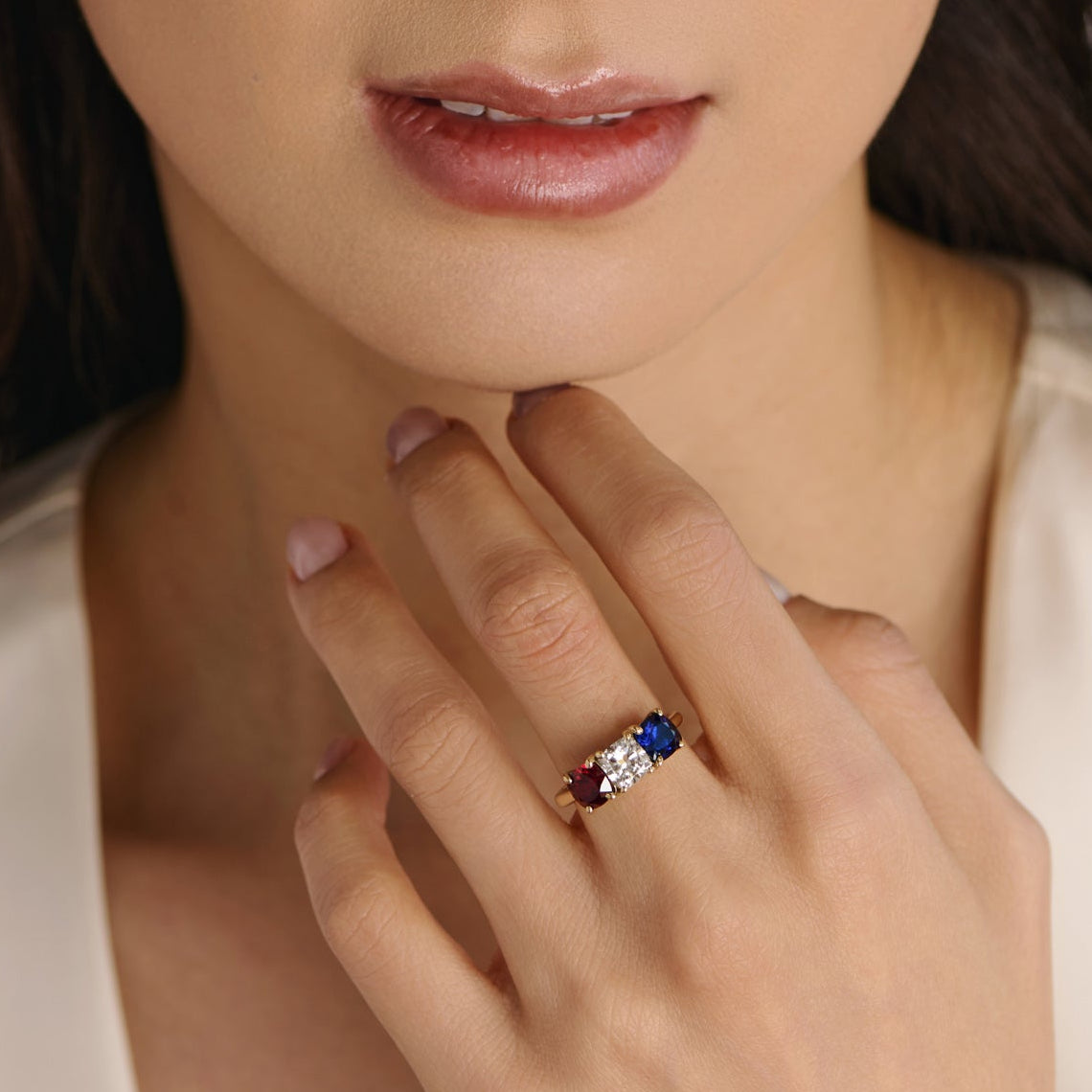 cushion-cut lab-grown diamond ring with ruby and sapphire side stones in three-stone setting