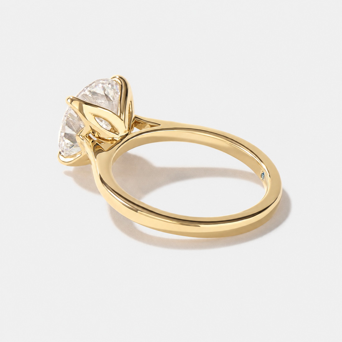 Tulip-set round lab-grown diamond solitaire engagement ring with graceful prongs and a slender band.
