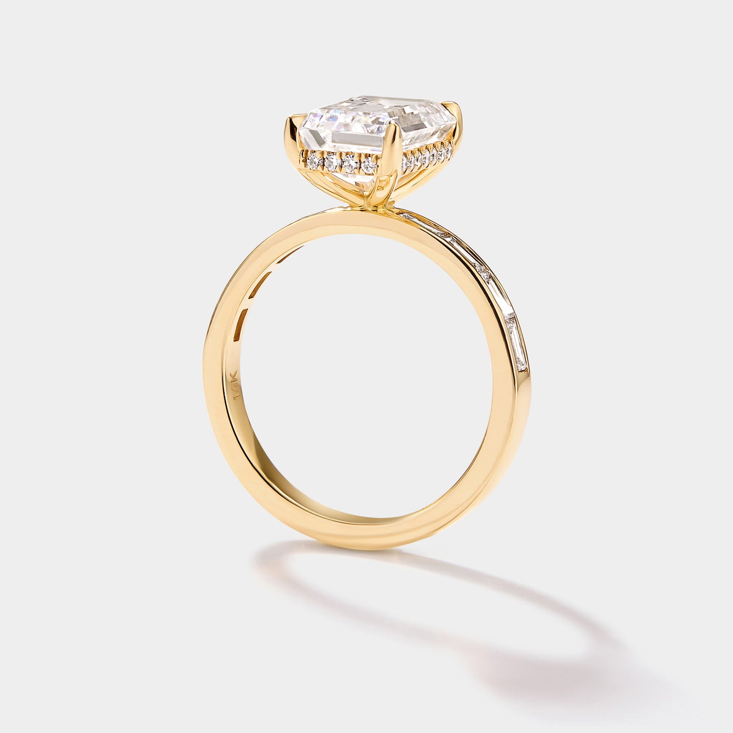 Close-up of the hidden diamond halo beneath an emerald-cut lab-grown diamond engagement ring