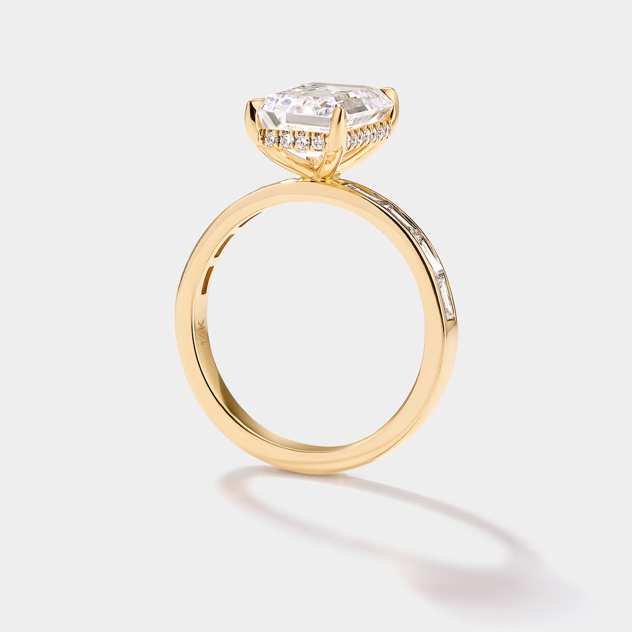 Close-up of the hidden diamond halo beneath an emerald-cut lab-grown diamond engagement ring