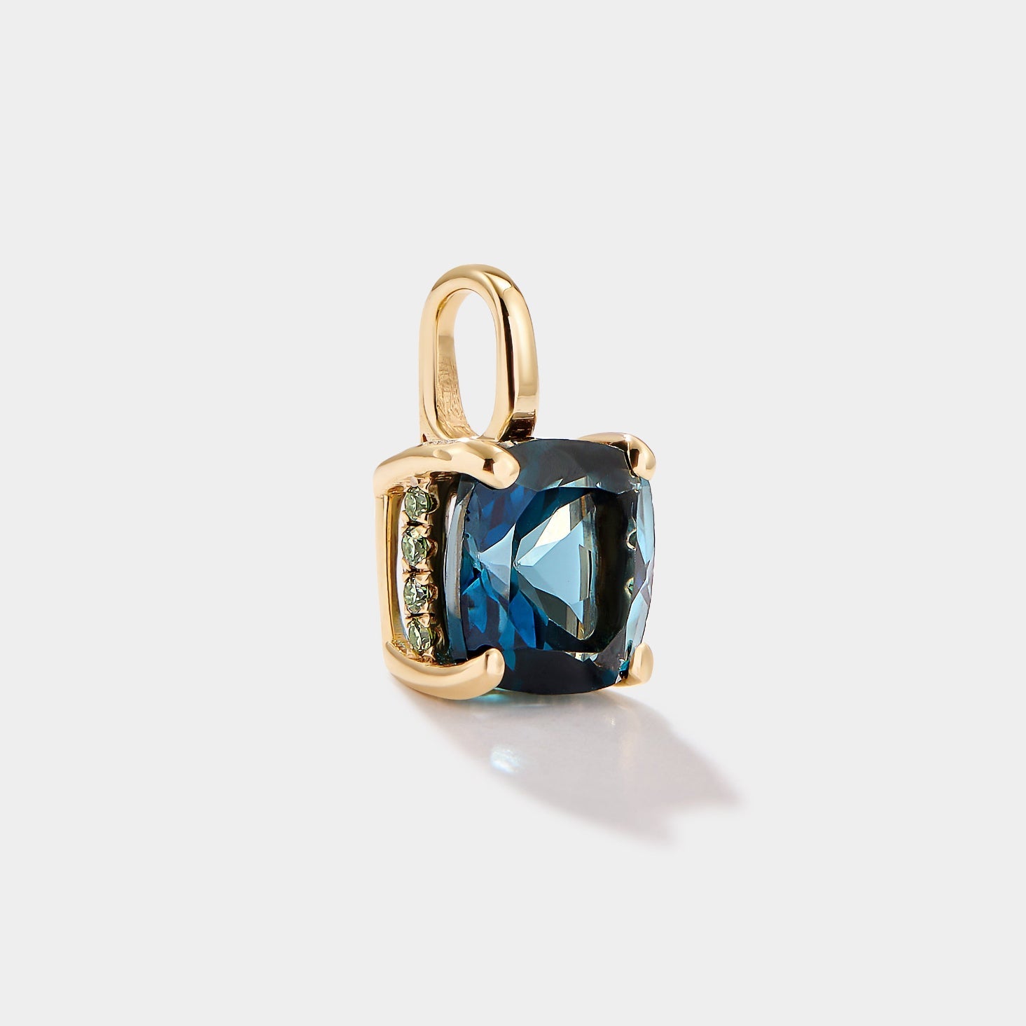 Cushion cut London blue topaz pendant in 14k gold with green lab diamond accents inspired by the Wequassett ring by Cove Fine Jewelry.