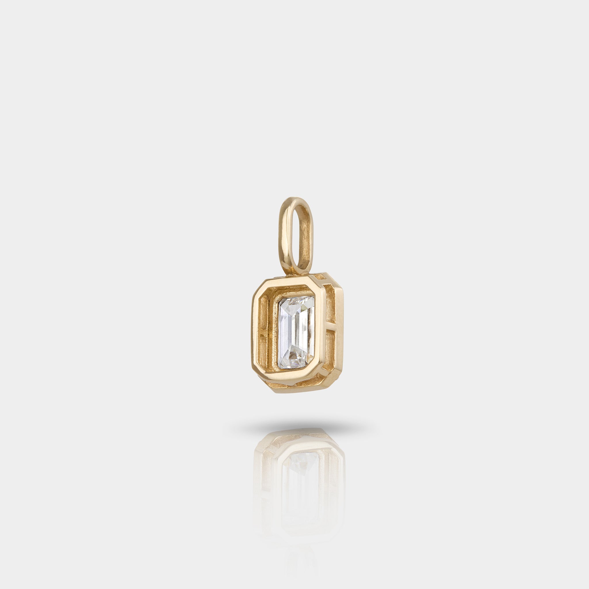 A emerald cut diamond pendant in 14k gold. 